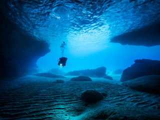 Seascape of coral reef in the Caribbean Sea around Curacao at dive site Blue Room, a special cave