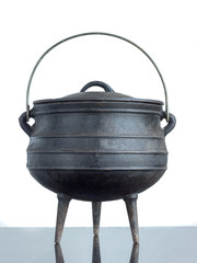 close up of black cast iron pot South African potjie pot isolated on white