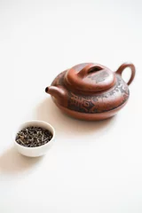 Foto op Aluminium Clay teapot and the white drinking bowl of chinese tea on white background © Vladyslava