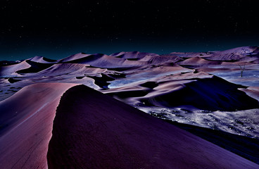 desert of namib at night with orange sand dunes and starry sky