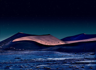 desert of namib at night with orange sand dunes and starry sky