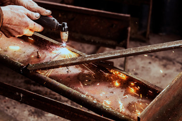 Cutting steel with plasma. Male welder cuts metal plasma.