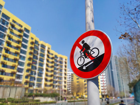 Bicycle Traffic signs on city road with resident building background, real estate price drop down Caution and warn concept.