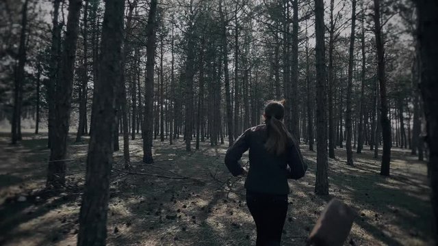 Frightened young woman escapes from serial killer with axe in woods