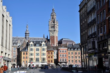 Magnificent belfry in Lille city and baroque facades of Grandplace buildings