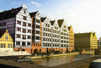 Obraz premium Postcard View of Gdansk, Poland over the river at sunset