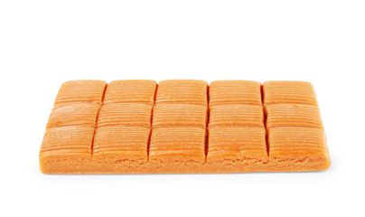 Four square pieces toffee caramel close-up isolated on white background