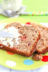 Two piecies Banana bread healthy tasty breakfast Loaf walnuts icing cream cheese Green light plate background Selective focus
