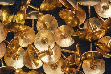 Stationery for office. Golden-colored stationery buttons. Many buttons