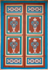 Beautiful ancient ornament painted on wooden shutter