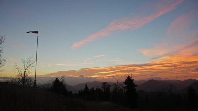 Early Windy Sunrise at the Top of a Moutain with a Wind Cone