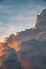 Dramatic large cumulus clouds on the sky at sunset