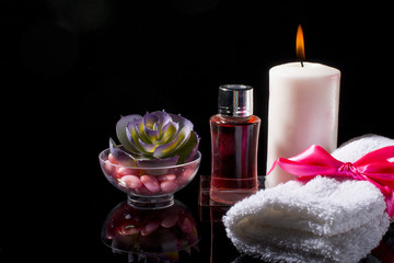 Spa with bottled oils on a black background.
