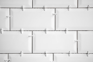 Ceramic tile lying. Installing new subway or metro tiles in bathroom, shower or kitchen back splash...