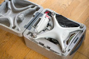 Fototapeta premium Two brand new unboxed drones in carry boxes. Concept of rapid technology development and comparing two devices