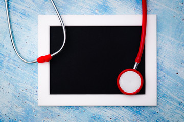 World health day, healthcare and medical concept, red stethoscope and photo frame for copy space