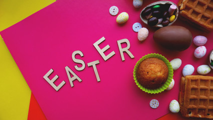 Decor Easter eggs on pink background. Flat lay, top view. Easter concept banner. Easter text