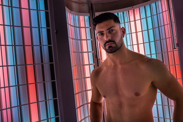 Portrait of muscle guy in collagen solarium