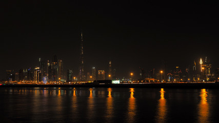Fototapeta premium Modern city panoramic landscape by night. Beautiful Dubai cityscape. United Arab Emirates