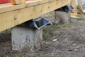 Concrete pillars base for structure of the house with wooden carcass