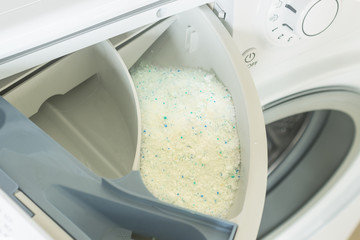 Detergent in the washing machine in laundromat. Concept- detergent dosage, housework, house cleaning.