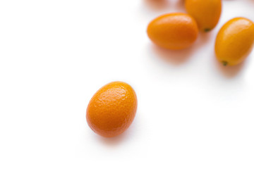 Kumquats or cumquats (Citrus japonica) isolated on white background