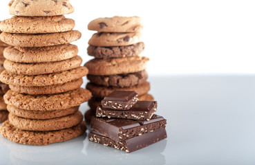Various shortbread, oat cookies, chocolate chip biscuit and pieces of chocolate with seeds and nuts.