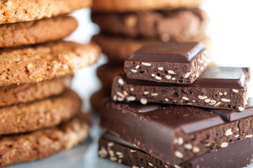 Various shortbread, oat cookies, chocolate chip biscuit and pieces of chocolate with seeds and nuts.