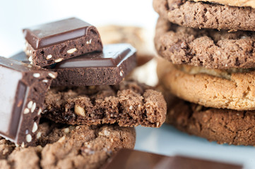 Various shortbread, oat cookies, chocolate chip biscuit and pieces of chocolate with seeds and nuts.