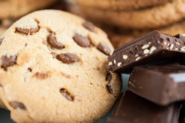 Various shortbread, oat cookies, chocolate chip biscuit and pieces of chocolate with seeds and nuts.