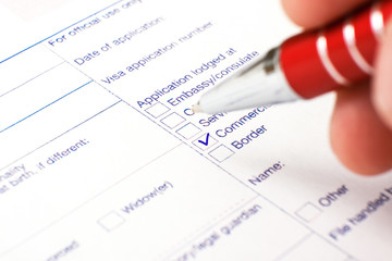 Schengen visa, questionnaire. Hand with pen completing a questionary.