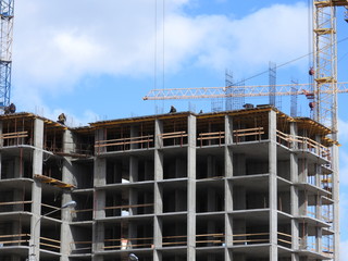 Aerial photograph of an unrecognized civil engineer without a face, watching the work of roof builders on the construction site. The concept of building with copy space.