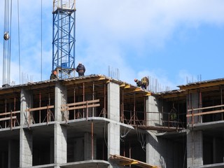 Aerial photograph of an unrecognized civil engineer without a face, watching the work of roof...
