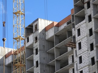 Aerial photograph of an unrecognized civil engineer without a face, watching the work of roof...