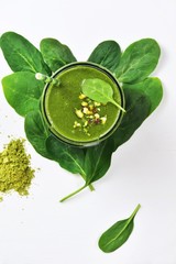 Super green spinach smoothie with matcha green tea isolated on white background. Top view green smoothie