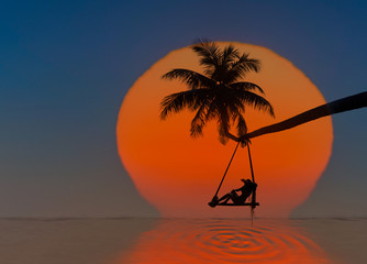 Fairy tale sunset of the large sun drop into the sea with lonely woman sitting on wooden swing under coconut palm tree over the sea beach, enjoy or lonely feel in  long holidays vacation in summer