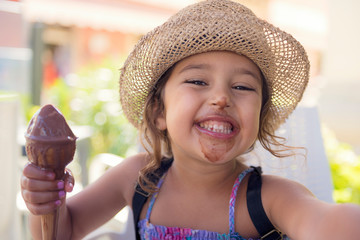 Girl smiling with her mouth smeared with ice cream