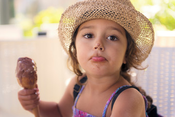 Girl with nose smeared with chocolate ice cream