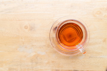 Top view of Hot tea in a cup on wooden table in the coffee shop, image with copy space.