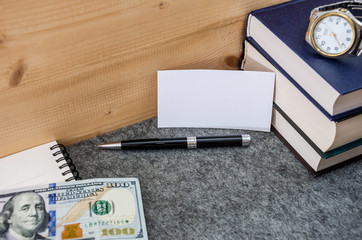 white frame for writing on the background of books, notebook, pens and dollars