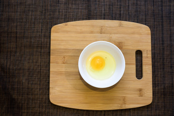 Fresh Egg With Bowl of Egg White on Wooden Table, Food Rustic Style.