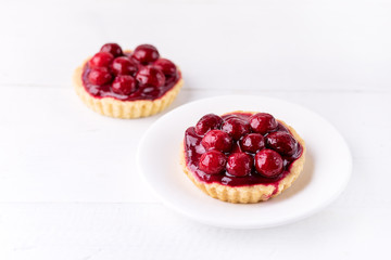 Fresh Homemade Tartlets Tart with Berries on White Background Tasty Tarts Decorated with Red Berries Horizontal Copy Space Beautiful Dessert