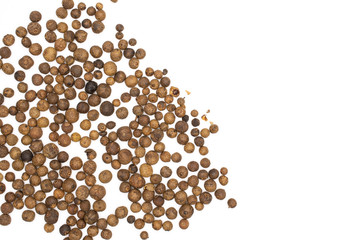 Lot of whole dry brown allspice berries flatlay isolated on white background
