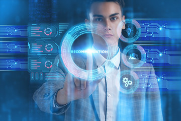 The concept of business, technology, the Internet and the network. A young entrepreneur working on a virtual screen of the future and sees the inscription: Recommendation