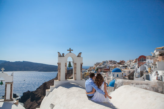 young couple honeymoon on the most romantic island Santorini, Greece