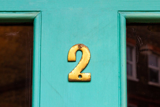 House Number Two With The 2 In Golden Bronze On A Light Green House Door