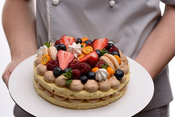 Girl Pastry Chef, makes a cake with his own hands. Copy space. Selective focus.