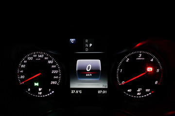 car speedometer dashboard display with the ignition and parking sensor illuminated.