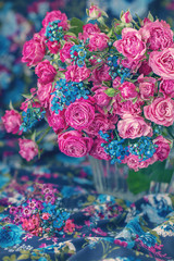 Close-up floral composition with a pink roses on a colorful background..Many beautiful fresh pink roses on a table.