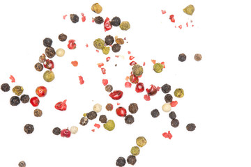 Lot of whole peppercorns of four colors flatlay isolated on white background